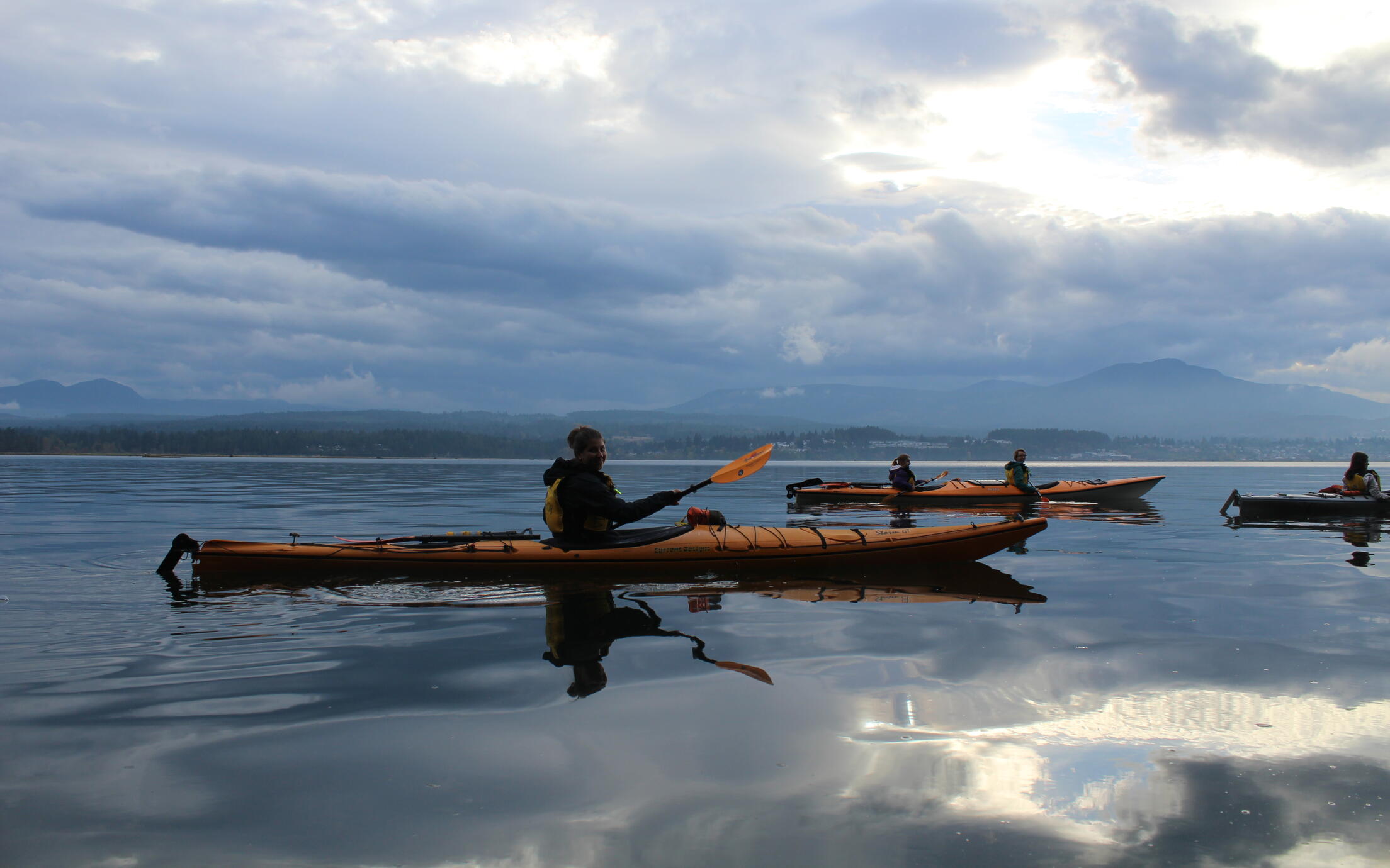 Paddlers in kayaks on the ocean